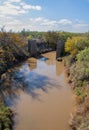 Very muddy river and the base of the destroyed old bridge