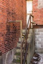 Very narrow concrete stairway on back of a abandoned red brick building Royalty Free Stock Photo