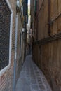 Very narrow old, vintage street in Venice. Curvy narrow road in