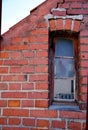 Very narrow window in an old brick wall Royalty Free Stock Photo