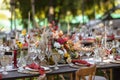 A very nicely decorated wedding table appointments with beautiful decor with plates and serviettes in spring garden Royalty Free Stock Photo