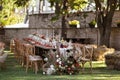 A very nicely decorated wedding table appointments with beautiful decor with plates and serviettes in spring garden Royalty Free Stock Photo