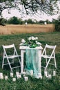 A very nicely decorated wedding table with beautiful decor with plates and serviettes in garden Royalty Free Stock Photo