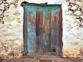 A very old, ailing and with the most diverse paint residues provided wooden door with two wing doors