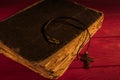 Very old ancient holy bible and neckalce cross. Royalty Free Stock Photo