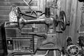 very old antique looking sewing machine and old antique radio. black and white photo.