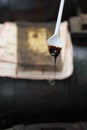 very old Balsamic Vinegar of Modena dripping from a spoon