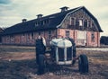 A very old barn with a old antique tractor in front. Royalty Free Stock Photo