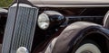 very old black classic car detail from front and lights panorama Royalty Free Stock Photo