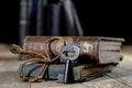 Very old book and key on an old wooden table. Old room, wooden t Royalty Free Stock Photo