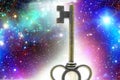 Very old brass key against a space background symbolizing unlocking infinite wisdom Royalty Free Stock Photo