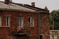 An old, historic red brick building. Against the background of the gray sky . Royalty Free Stock Photo