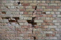 Very old brick stone wall of castle or fortress of 18th century. Full frame wall with obsolete dirty and cracked bricks