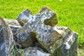 Very old broken statue and headstone in a cemetery