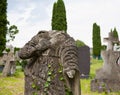 An very old broken statue of Mary old cemetery. Overgrown with ivy concept death, religion Royalty Free Stock Photo