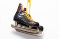 Very old brown leather ice skates hang on a white wall as decoration. Royalty Free Stock Photo