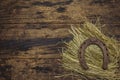 Very old cast iron metal horse horseshoe on hay. Good luck symbol, St.Patrick`s Day concept. Antique wooden background, horse Royalty Free Stock Photo
