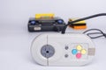 Very old console on a white background. The controller in the foreground