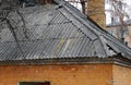 Very old damaged asbestos slate roof and chimney