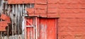 A very old deserted red empty abandoned farm barn building structure shed with deteriorating faded Royalty Free Stock Photo