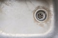 Very old dirty sink with rusty metal drain