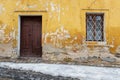 Very old door and window in a wall with peeling plaster Royalty Free Stock Photo