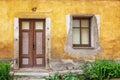 Very old door and window in a wall with peeling plaster Royalty Free Stock Photo