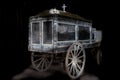 Very old and dusty hearse made of wood with large wooden wheels. Used to transport the coffin with the dead during the funeral in Royalty Free Stock Photo