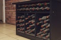 Very old and expensive bottles of collection wine lie in the dust on a dark shelf. Selective focus Royalty Free Stock Photo