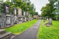 Very old graves located next to dwellings in Greyfriars Cemetery in Edinburgh, Scotland.