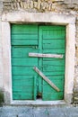 Very old green rustic wood door / Housing insurance. Background, texture and material Royalty Free Stock Photo