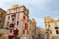 The very old houses with red windows and balconies at Liesse street in Valletta, Malta Royalty Free Stock Photo