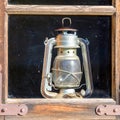 a very old kerosene lamp in the house by the window Royalty Free Stock Photo