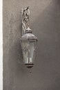 Very old lantern with candles hanging on gray concrete wall Royalty Free Stock Photo