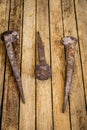 very old large nails on a beautiful wooden background, rusty Royalty Free Stock Photo