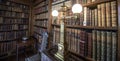 Very old library, 16th Century bookshelves with old fashioned light