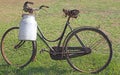 Very old milking bicycle with aluminum milk canister Royalty Free Stock Photo