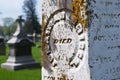 Very old moss covered broken statue / headstone in a cemetery