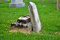 Very old moss covered broken statue headstone in a cemetery