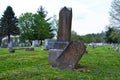 Very old moss covered broken statue / headstone in a cemetery