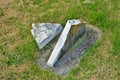 Very old moss covered broken statue / headstone in a cemetery