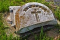 Very old moss covered broken statue / headstone in a cemetery