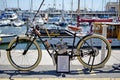 A very old motorcycle standing by the harbour in Ramsgate Kent England.