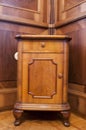 A very old nightstand with a vintage floor and wall Royalty Free Stock Photo