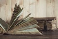 Two antique shabby books on light wooden background. Royalty Free Stock Photo