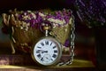 Very old pocket watch with chain and floral decoration on a table Royalty Free Stock Photo