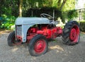 Very old red farm tractor in the field. Royalty Free Stock Photo