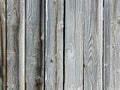 Very old retro weathered aged wood fence siding wall with knots and natural sunlight with shadows