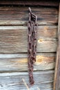 Old rosty chain on a barn wall