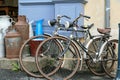 Very old rustic vintage bicycles and milk cans